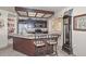 Well-lit kitchen with a center island, bar stools, and a cozy breakfast nook at 7645 W Bluefield Ave, Glendale, AZ 85308