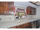 A well-lit sink area complements the functional design of this rustic kitchen space at 7645 W Bluefield Ave, Glendale, AZ 85308