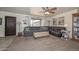 Inviting living room with plush carpeting, a ceiling fan, and comfortable seating at 7645 W Bluefield Ave, Glendale, AZ 85308