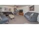 Cozy living room with carpet, ceiling fan, and comfortable seating arrangement at 7645 W Bluefield Ave, Glendale, AZ 85308
