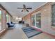 Bright sunroom with tile flooring, brick walls, and large windows, great for entertaining at 7645 W Bluefield Ave, Glendale, AZ 85308