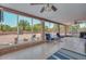Enclosed sunroom with brick walls, tile floor and seating at 7645 W Bluefield Ave, Glendale, AZ 85308