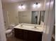 Bathroom featuring double sink vanity, a toilet, and large mirror above the sink at 12041 W Carlota Ln, Sun City, AZ 85373