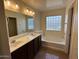Bathroom with a double sink vanity and bathtub at 12041 W Carlota Ln, Sun City, AZ 85373