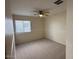 Neutral bedroom featuring carpet, a window, and ceiling fan at 12041 W Carlota Ln, Sun City, AZ 85373