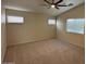 A bright and spacious bedroom featuring neutral paint and carpet at 12041 W Carlota Ln, Sun City, AZ 85373