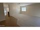 An open dining room featuring carpet flooring and a modern chandelier at 12041 W Carlota Ln, Sun City, AZ 85373