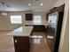 Bright kitchen featuring stainless steel appliances, white countertops, and dark cabinets at 12041 W Carlota Ln, Sun City, AZ 85373