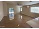 An open-concept living room with tile flooring, large windows, and a sliding glass door at 12041 W Carlota Ln, Sun City, AZ 85373