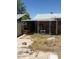 View of a backyard featuring a covered patio and some unkempt vegetation at 18415 N 33Rd Ave, Phoenix, AZ 85053