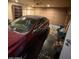View of car in cluttered garage at 18415 N 33Rd Ave, Phoenix, AZ 85053