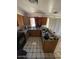 Functional kitchen with stainless steel appliances, wood cabinets, and tile floors at 18415 N 33Rd Ave, Phoenix, AZ 85053