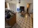 Functional kitchen with stainless steel appliances, wood cabinets, and tile floors at 18415 N 33Rd Ave, Phoenix, AZ 85053