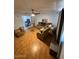 Cozy living room with ceiling fan, wood floors, and open to dining area at 18415 N 33Rd Ave, Phoenix, AZ 85053