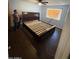 Bedroom featuring a dark sleigh bed frame, ceiling fan, and wood-look floors at 18415 N 33Rd Ave, Phoenix, AZ 85053