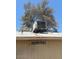 An older-style air conditioning unit on a roof with a window below at 18415 N 33Rd Ave, Phoenix, AZ 85053