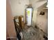 View of water heater, utility supplies and floor at 18415 N 33Rd Ave, Phoenix, AZ 85053