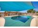 Lovely backyard featuring a stainless steel grill, and a refreshing pool under a blue sunshade at 2164 E Jerome Ave, Mesa, AZ 85204