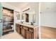 Modern bathroom featuring a double sink vanity with wood cabinets and a shower with tiled accent wall at 2164 E Jerome Ave, Mesa, AZ 85204