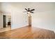 Bright bedroom with hardwood floors, access to a bathroom, and a view of an organized closet system at 2164 E Jerome Ave, Mesa, AZ 85204