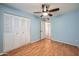 Bedroom featuring a ceiling fan, hardwood floors and a closet at 2164 E Jerome Ave, Mesa, AZ 85204