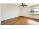 Comfortable bedroom showcasing hardwood flooring, neutral toned walls and a view of the well maintained backyard at 2164 E Jerome Ave, Mesa, AZ 85204