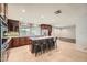 Modern kitchen with granite countertops, stainless steel appliances, an island, and dark wood cabinetry at 2164 E Jerome Ave, Mesa, AZ 85204