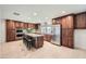 Modern kitchen featuring an island with seating, stainless appliances, and dark wood cabinets at 2164 E Jerome Ave, Mesa, AZ 85204