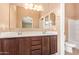 Bathroom featuring a dual-sink vanity, a large mirror, and a separate toilet area at 2725 E Mine Creek Rd # 1149, Phoenix, AZ 85024