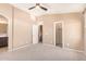 Spacious bedroom featuring neutral tones, a ceiling fan, and doors to the bathroom and closet at 2725 E Mine Creek Rd # 1149, Phoenix, AZ 85024