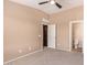 Bedroom featuring neutral tones, ceiling fan, and doors to the bathroom and linen closet at 2725 E Mine Creek Rd # 1149, Phoenix, AZ 85024
