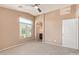 Bright bedroom featuring a large window, neutral tones, and doors to the bathroom and closet at 2725 E Mine Creek Rd # 1149, Phoenix, AZ 85024