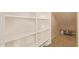 Walk-in closet with white shelves and tile flooring at 2725 E Mine Creek Rd # 1149, Phoenix, AZ 85024