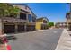 View of townhome exteriors showing garages and unit numbers, with well-maintained landscaping and street view at 2725 E Mine Creek Rd # 1149, Phoenix, AZ 85024
