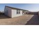 A full view of the side and back of a home and its spacious dirt backyard, perfect for landscaping at 2732 N 217Th Ave, Buckeye, AZ 85396
