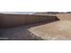 View of a dirt backyard with a tall brick wall at 2732 N 217Th Ave, Buckeye, AZ 85396