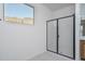 Modern bathroom showcases a glass-enclosed shower, vanity with mirror, and desert view at 2732 N 217Th Ave, Buckeye, AZ 85396