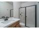 A modern bathroom with a black-trimmed shower and stylish countertop at 2732 N 217Th Ave, Buckeye, AZ 85396