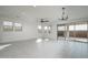 An empty living area with neutral tile floors and a sliding glass door at 2732 N 217Th Ave, Buckeye, AZ 85396