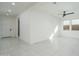 Bright, open living area with neutral tile, ceiling fan, and natural light at 2732 N 217Th Ave, Buckeye, AZ 85396
