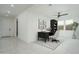 Bright, open living area staged with modern desk, chair and shelves at 2732 N 217Th Ave, Buckeye, AZ 85396