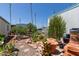 An inviting backyard is landscaped with cacti, various plants, pots, and a small bench seat at 4065 E University Dr # 76, Mesa, AZ 85205