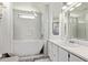 A pristine bathroom showcases a soaking tub, shower, and white vanity with a modern faucet and fixtures at 4065 E University Dr # 76, Mesa, AZ 85205