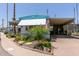 Charming manufactured home featuring a carport, manicured landscaping, and a welcoming curb appeal at 4065 E University Dr # 76, Mesa, AZ 85205