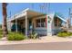Charming manufactured home with covered parking, small front porch and desert landscaping at 4065 E University Dr # 76, Mesa, AZ 85205