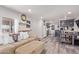 Inviting living room flows to kitchen with modern appliances and stylish gray wood flooring at 4065 E University Dr # 76, Mesa, AZ 85205