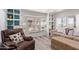 Cozy living room featuring built-in shelves, neutral paint, large windows and wood-look floors at 4065 E University Dr # 76, Mesa, AZ 85205