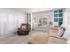 Cozy living room featuring built-in shelves, neutral paint, large windows and wood-look floors at 4065 E University Dr # 76, Mesa, AZ 85205