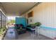 This covered patio includes comfortable seating, a coffee table, and plants for outdoor relaxation at 4065 E University Dr # 76, Mesa, AZ 85205