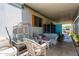 A charming covered patio is shown with wicker furniture and decorative pieces, creating a relaxing outdoor space at 4065 E University Dr # 76, Mesa, AZ 85205